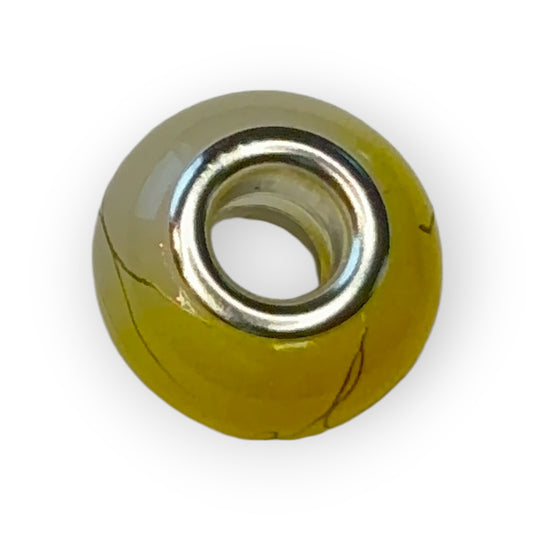 Charm esfera bicolor amarillo motivos dorados