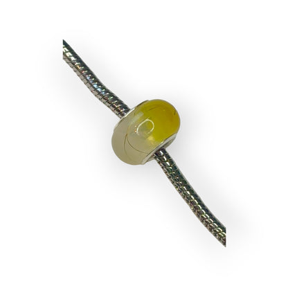 Charm esfera bicolor amarillo motivos dorados